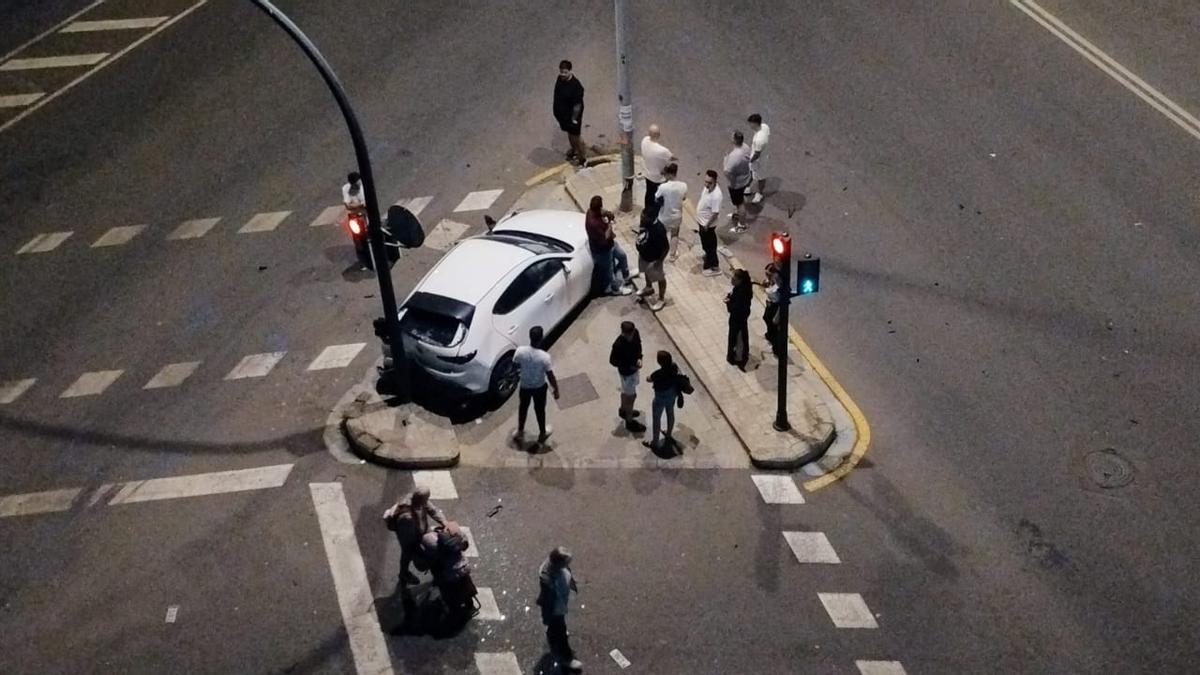 Curiosos se acercan al vehículo accidentado en la avenida Tres Forques.