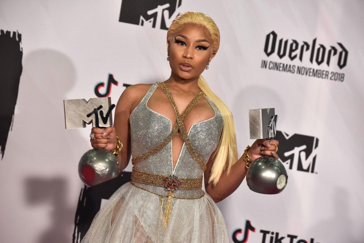 The singer Nicki Minaj poses with the awards she received, Best Hip-Hop Artist and Best Look, during the 2018 European Music Awards gala.