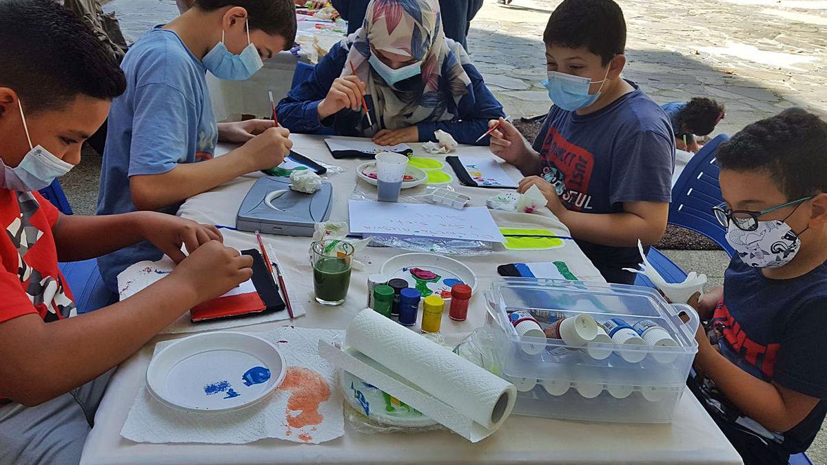 Participantes del proyecto de Accem dibujan al aire libre. |  // L. O.