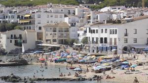 La platja de Calella de Palafrugell plena de banyistes.