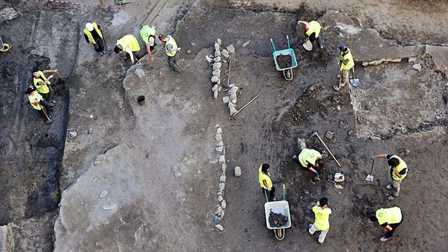 Piezas para conocer la historia local. Los yacimientos y restos de cerámica, vidrio, féretros... localizados por los técnicos ayudan a componer la historia local. En la imagen, técnicos trabajando este verano en un yacimiento descubierto en Rosalía de Castro. | MARTA G. BREA