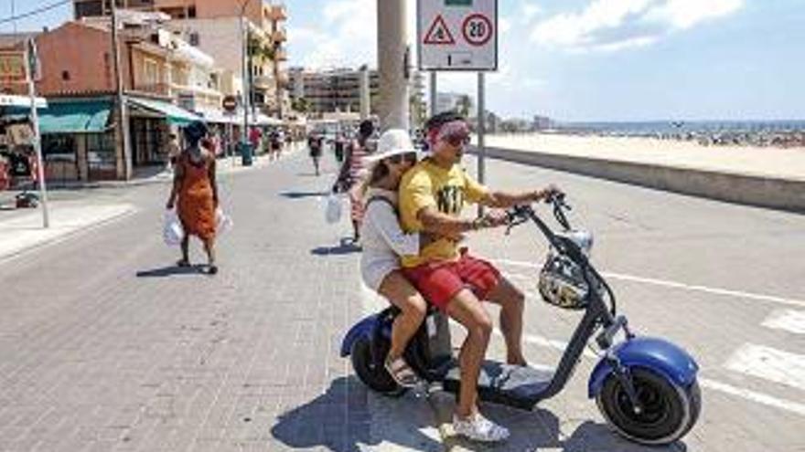 Ein Pärchen auf einem Elektro-Scooter an der Playa de Palma