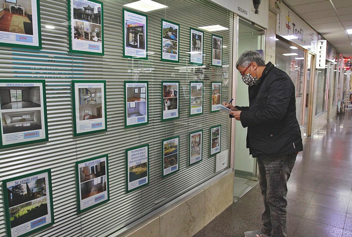 Un hombre observa las ofertas de pisos en una inmobiliaria. |   // IÑAKI OSORIO