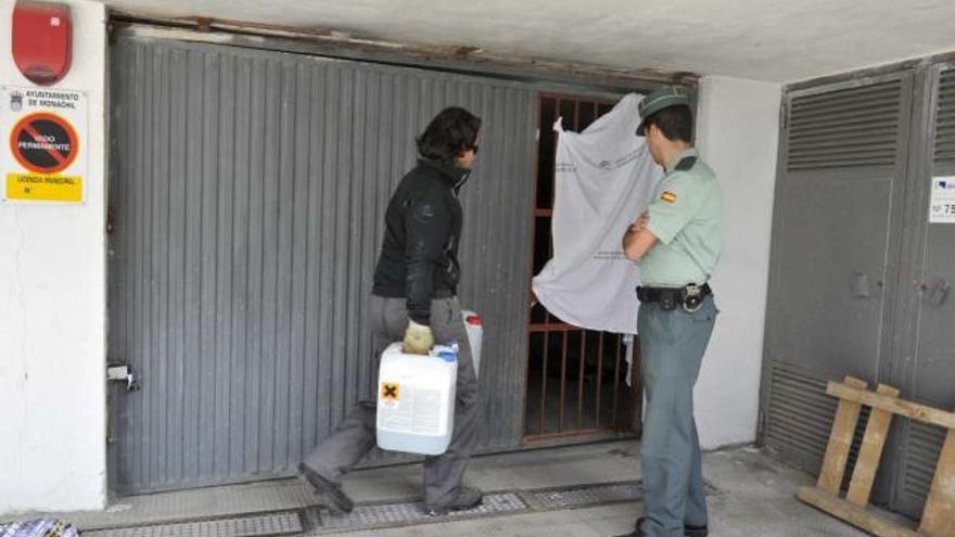 Un guardia civil junto a la puerta del garaje donde murió aplastado el ciclista