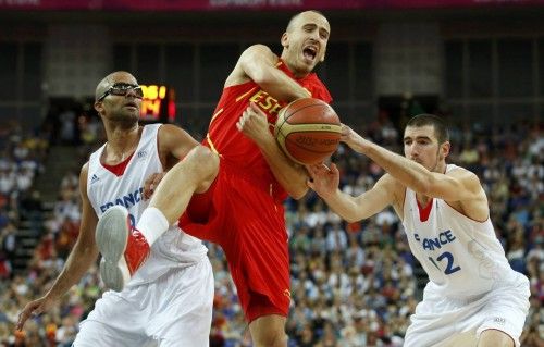 Spain's Rodriguez has the ball stripped away by France's de Colo and Parker during their men's quarterfinal basketball match at the North Greenwich Arena in London during the London 2012 Olympic Games