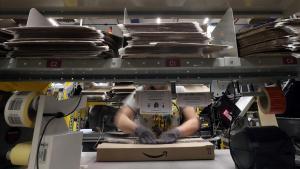 zentauroepp42522608 a worker packages an order at amazon distribution center in 180706110158