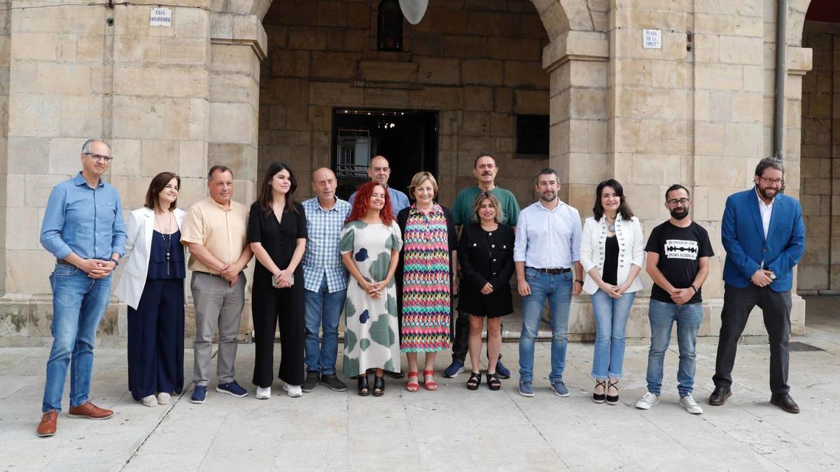 En primer fila, los miembros del gobierno avilesino y detrás, los máximos responsables locales del PSOE y de IU, delante del Ayuntamiento.