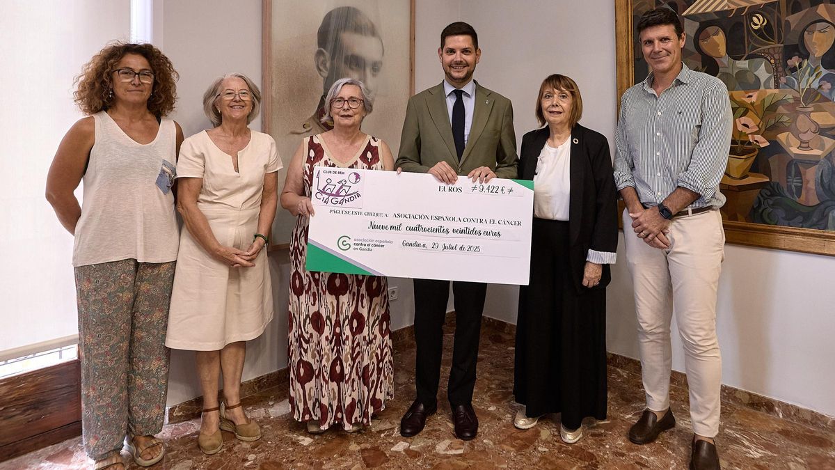 Los presentes en la recepción con el talón simbólico del dinero recaudado