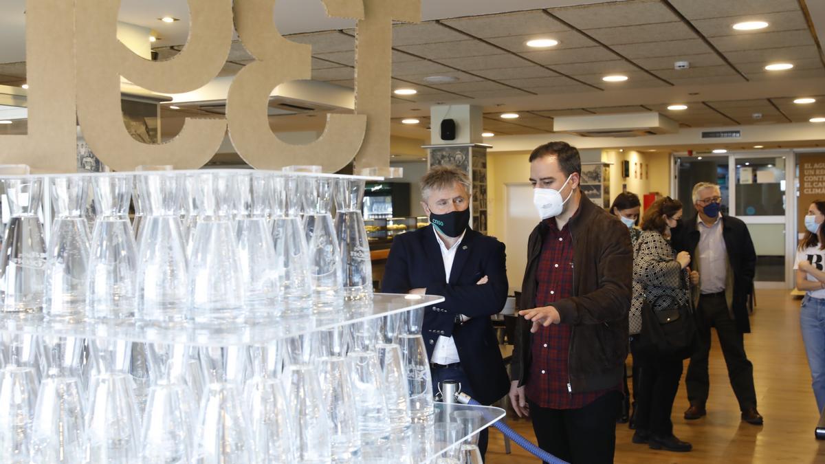 Olmo Ron, a la derecha, junto al presidente del Club Natación Santa Olaya, José Enrique Plaza, en la exposición sobre el agua inaugurada hoy en el club.