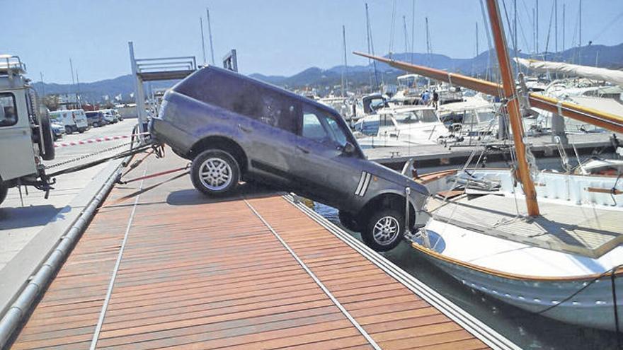 Otro todoterreno sujeta el Land Rover, que cayó sobre el llaüt, hasta que llegó un camión grúa y lo extrajo.