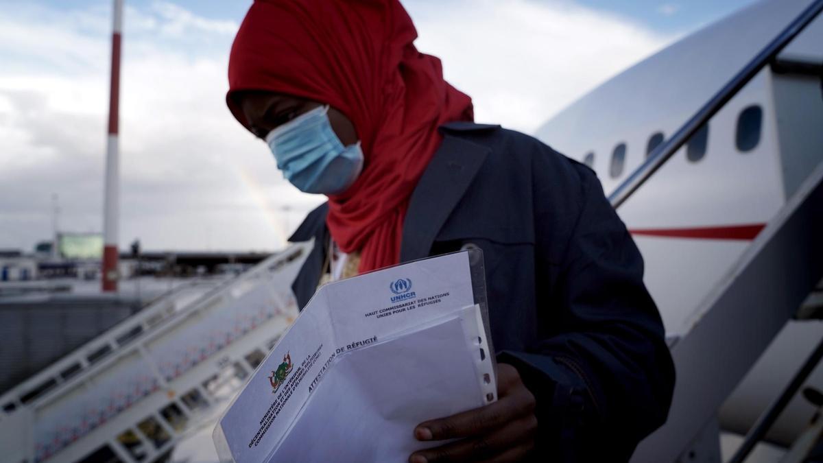 Una refugiada baja del avión, a su llegada al aeropuerto de Roma.