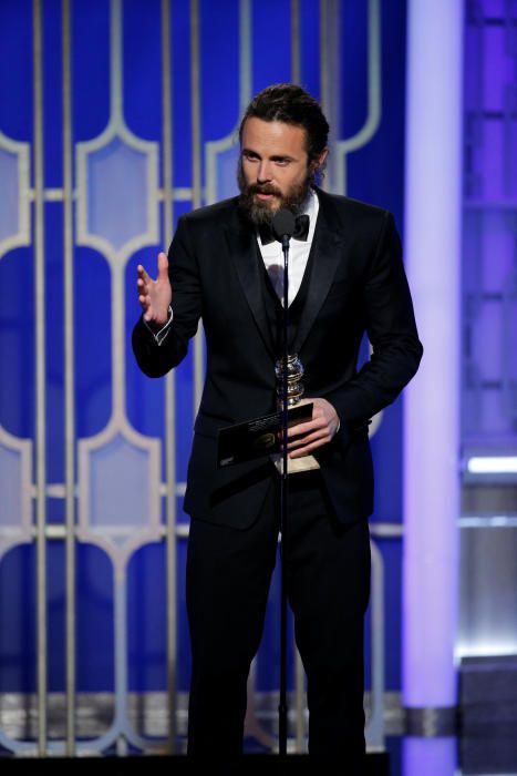Actor Casey Affleck holds the award for Best ...