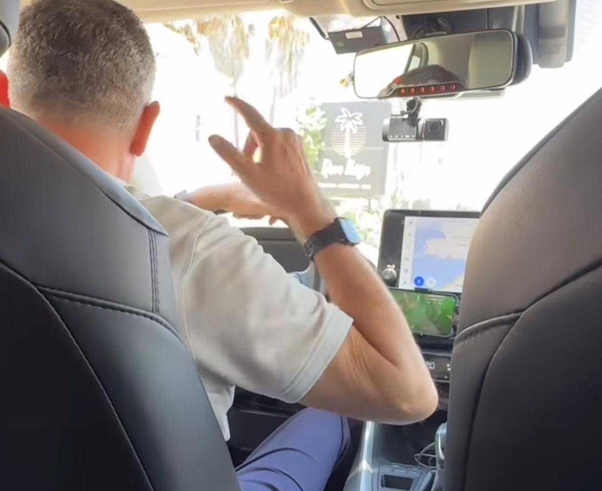 El taxista, moviendo una mano mientras baila