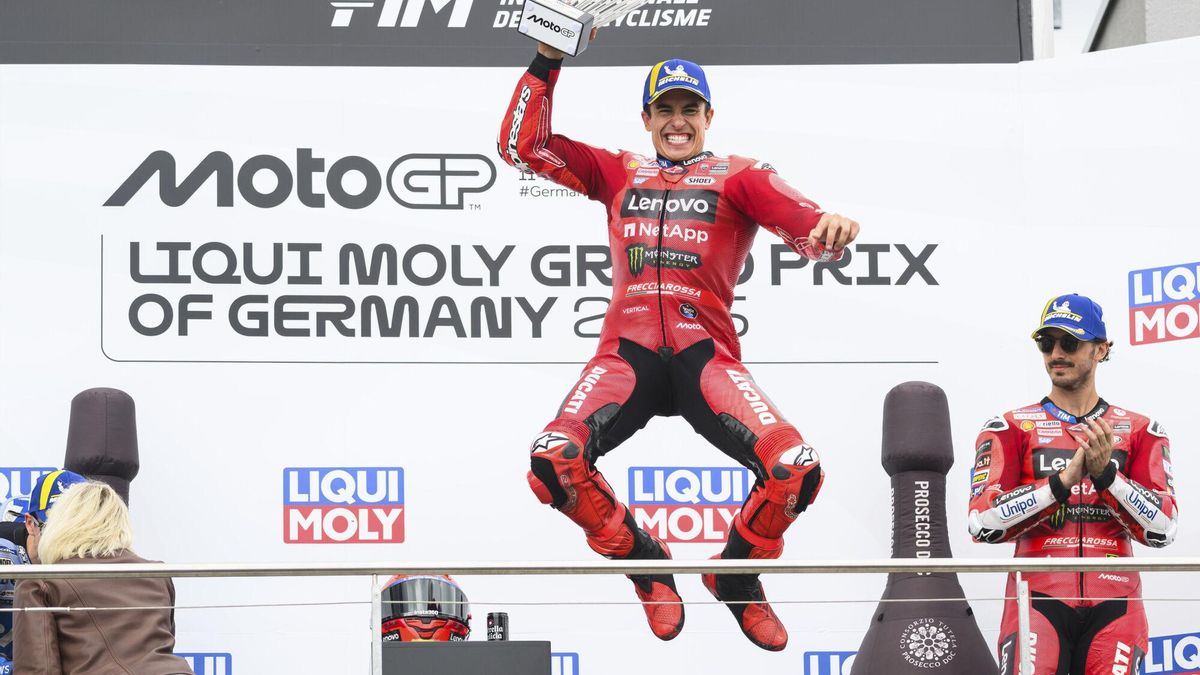 Winner Marc Marquez from Spain from the Ducati Lenovo Team celebrates on the podium next to third-placed Francesco "Pecco", right, Bagnaia from Italy of the Ducati Lenovo Team following the MotoGP race, German Grand Prix, at the Sachsenring circuit, in Hohenstein-Ernstthal, Germany, Sunday July 13, 2025. (Robert Michael/dpa via AP). GERMANY OUT; MANDATORY CREDIT
