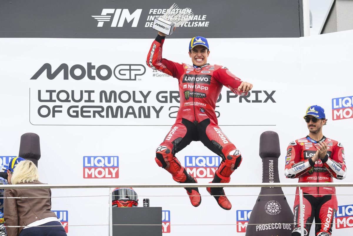 Winner Marc Marquez from Spain from the Ducati Lenovo Team celebrates on the podium next to third-placed Francesco Pecco, right, Bagnaia from Italy of the Ducati Lenovo Team following the MotoGP race, German Grand Prix, at the Sachsenring circuit, in Hohenstein-Ernstthal, Germany, Sunday July 13, 2025. (Robert Michael/dpa via AP). GERMANY OUT; MANDATORY CREDIT