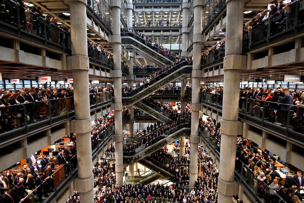 Workers stand during a Remembrance Service at ...