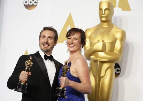 Patrick Osborne and Kristina Reed pose with their award for best animated short film for "Feast" during the 87th Academy Awards in Hollywood, California