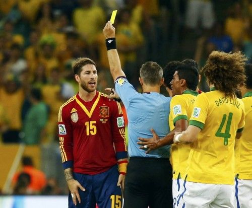 Referee Bjorn Kuipers of the Netherlands shows the yellow card to Spain's Sergio Ramos during their Confederations Cup final soccer match against Brazil at the Estadio Maracana in Rio de Janeiro