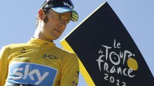 FILE - In this Sunday, July 22, 2012 file photo, Bradley Wiggins, winner of the 2012 Tour de France cycling race, looks back on the podium in Paris, France. Former Tour de France champion Bradley Wiggins says he is gutted and likely to miss this years race as his team is focusing on his bitter rival and defending champion Chris Froomes title defense. Wiggins told BBC Breakfast program on Friday, June 6, 2014, as it stands, I wont be there. The team is focused around Chris Froome. I am gutted. Ive worked extremely hard for this throughout the winter and up to the summer. I feel I am in the form I was two years ago. (AP Photo/Laurent Cipriani, File)