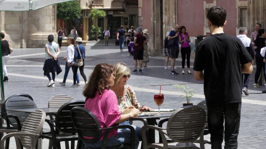 Dos turistas en una terraza de la plaza Belluga de Murcia. | JUAN CARLOS CAVAL