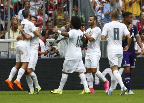 Real Madrid's Rodriguez celebrates his goal with team mate Danilo during their pre-season Audi Cup tournament soccer match against Tottenham Hotspur in Munich