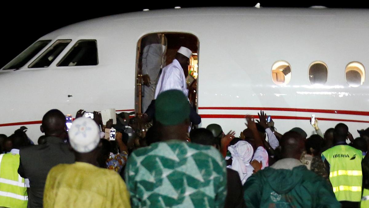 Former Gambian President Yahya Jammeh boards a plane at the airport as he flying into exile from Gambia