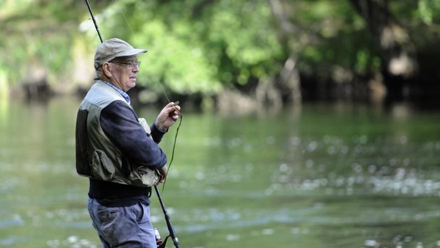 Pescadores en el río y en la ribera, en la primera jornada de pesca. |