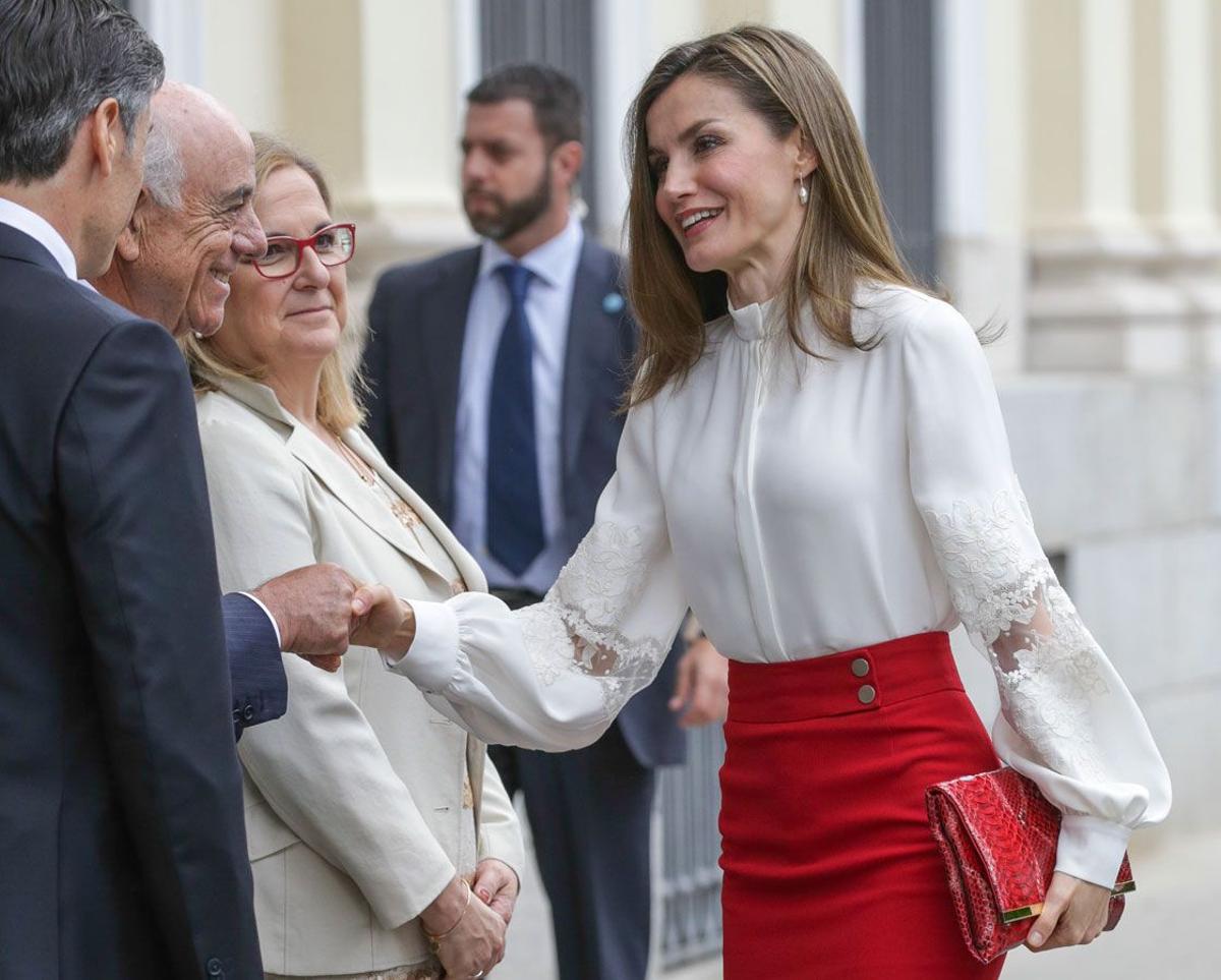 Detalle de la cartera roja de Letizia Ortiz con falda roja de Hugo Boss y camisa blanca