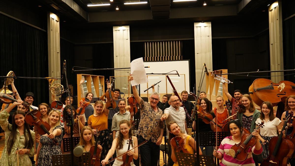 Luis Ivars y el director Sasho Tatarchevski, junto a la orquesta de jóvenes.