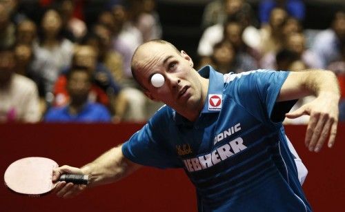Austria's Habesohn eyes the ball as he serves to China's Ma during their men's quarter final match at the World Team Table Tennis Championships in Tokyo