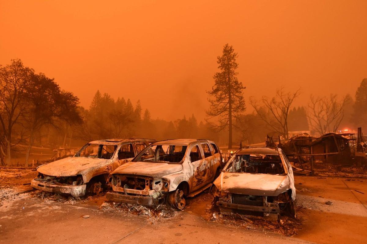 TOPSHOT - Abandoned vehicles sit at a car lot in Paradise, north of Sacramento, California on November 09, 2018. - A rapidly spreading, late-season wildfire in northern California has burned 20,000 acres of land and prompted authorities to issue evacuation orders for thousands of people. As many as 1000 homes, a hospital, a Safeway store and scores of other structures have burned in the area as the Camp fire tore through the region. (Photo by Josh Edelson / AFP)