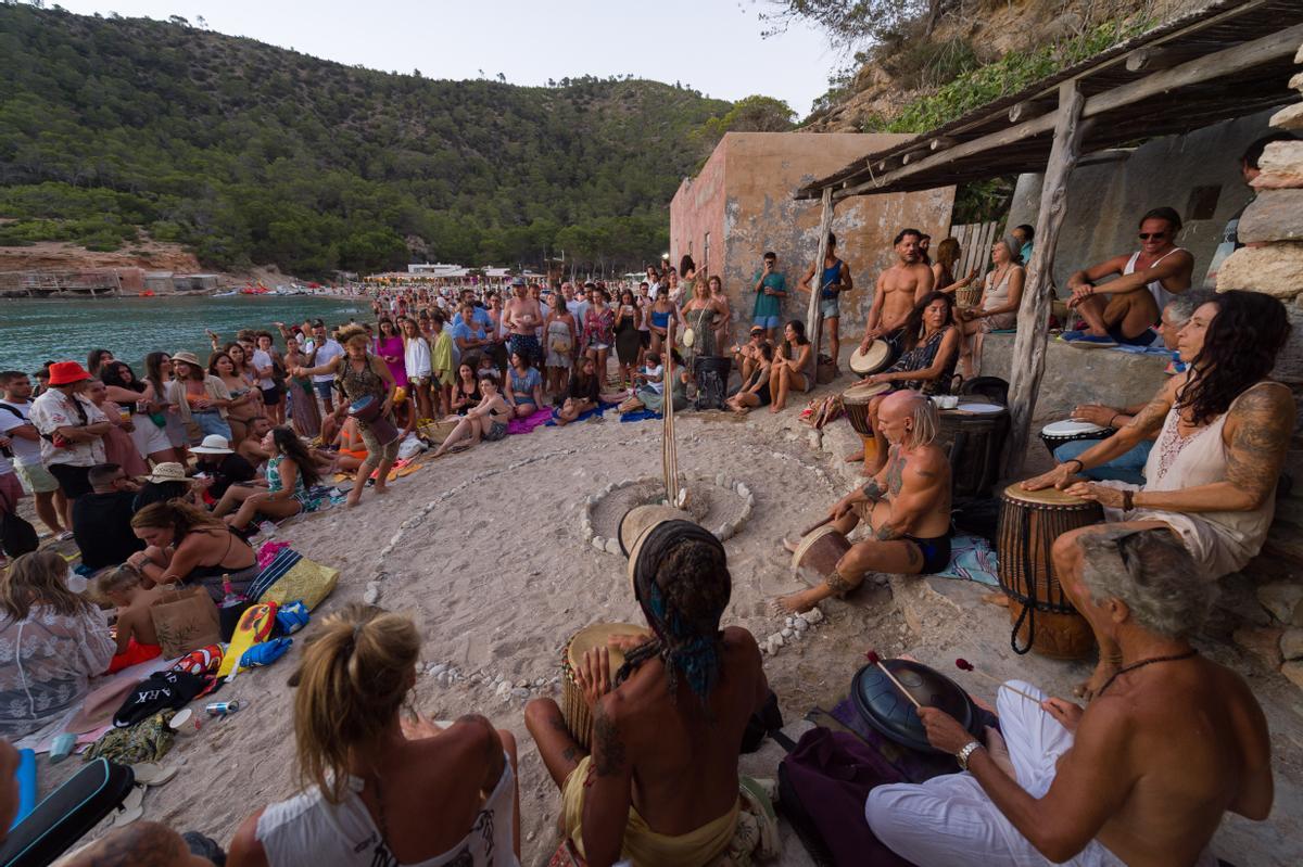 Un grupo de personas participan en la Fiesta de los Tambores en la Cala Benirrás