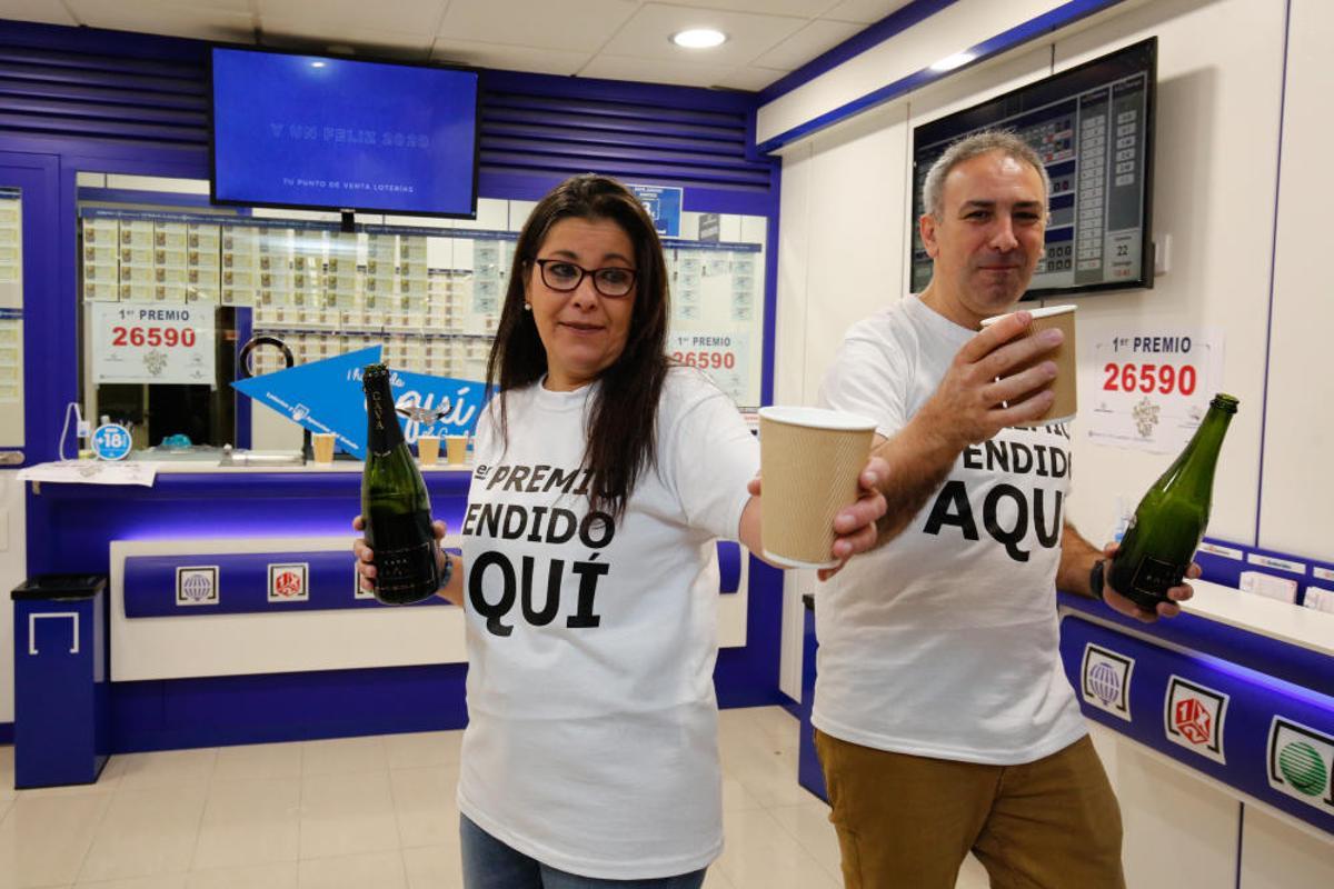 Los loteros Mercedes Mico y Fernando Petisco celebran que el Gordo ha sido vendido en su establecimiento de Salamanca.
