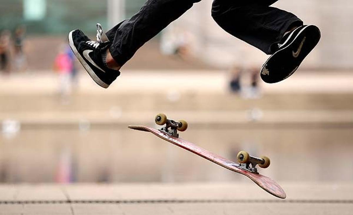 Un jove fa piruetes mentre la seva taula de ’skate’ gira per l’aire al Hyde Park de Sydney (Austràlia).