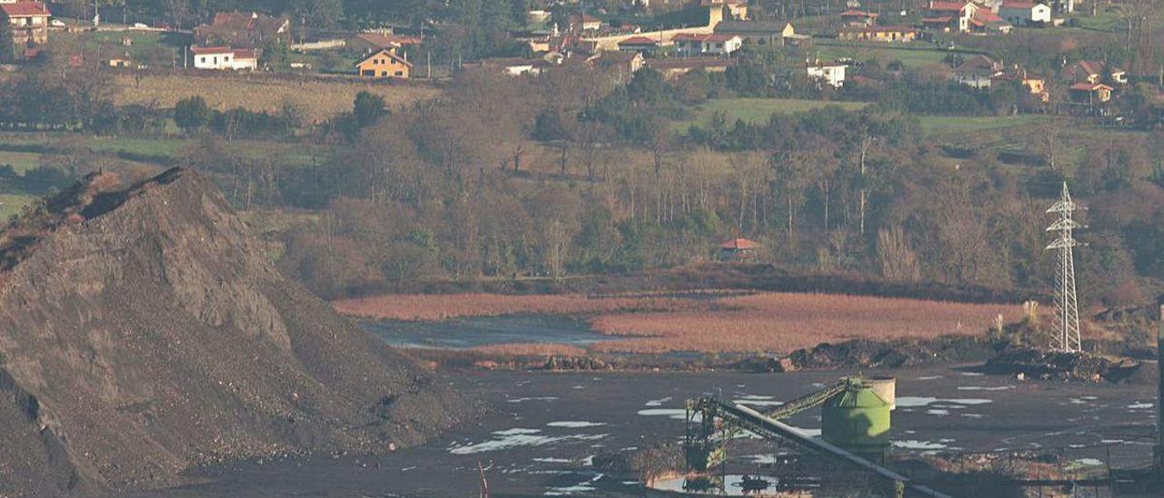 A la izquierda, la escombrera norte de Mina La Camocha, con la balsa de lodos a continuación.