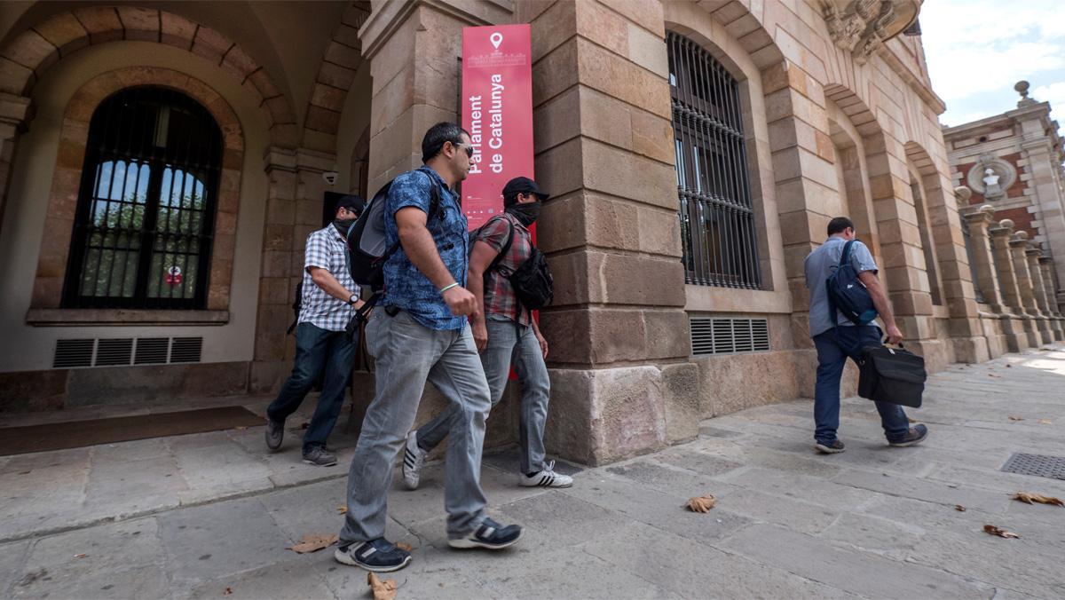 Agents de la Guàrdia Civil sortint del Parlament.