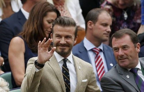 Former England soccer captain David Beckham waves after arriving on Centre Court at the Wimbledon Tennis Championships, in London
