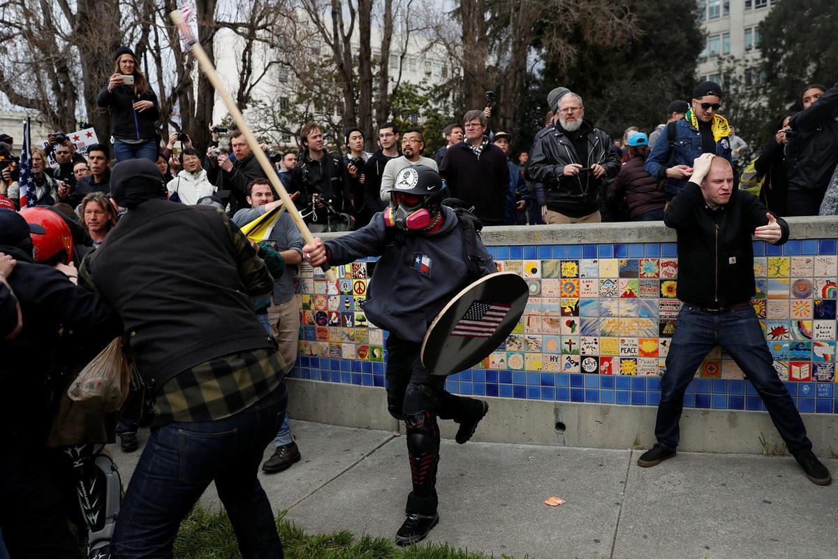 A demonstrator in support of U.S. President Donald Trump swings a stick towards a group of counter-protesters during a People 4 Trump rally in Berkeley, California March 4, 2017. REUTERS/Stephen Lam