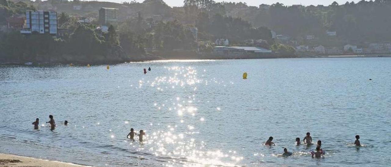 Un grupo de niños bañándose ayer en la playa de Banda do Río, en el centro de Bueu. // Gonzalo Núñez