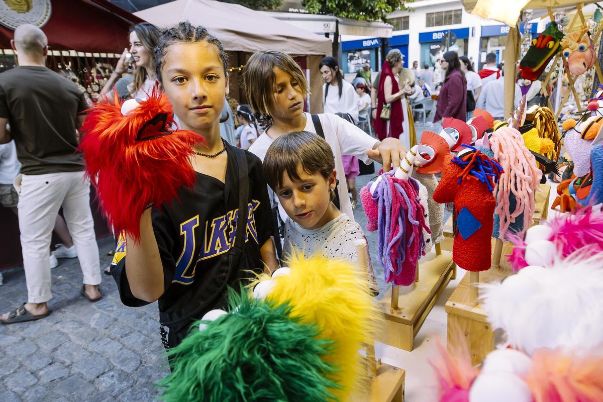 Niños observando y jugando con las marionteas.