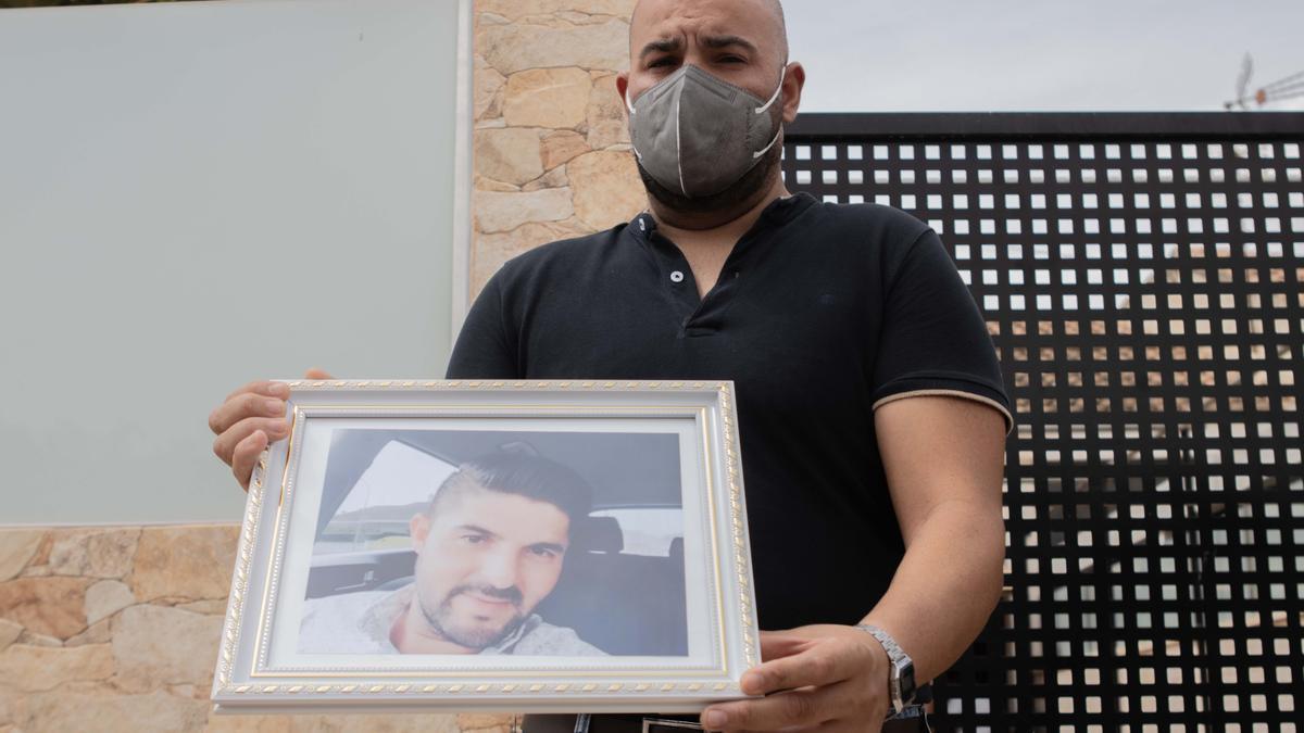Adán, hermano de la víctima, muestra la foto de Juan Manuel, horas después del crimen.