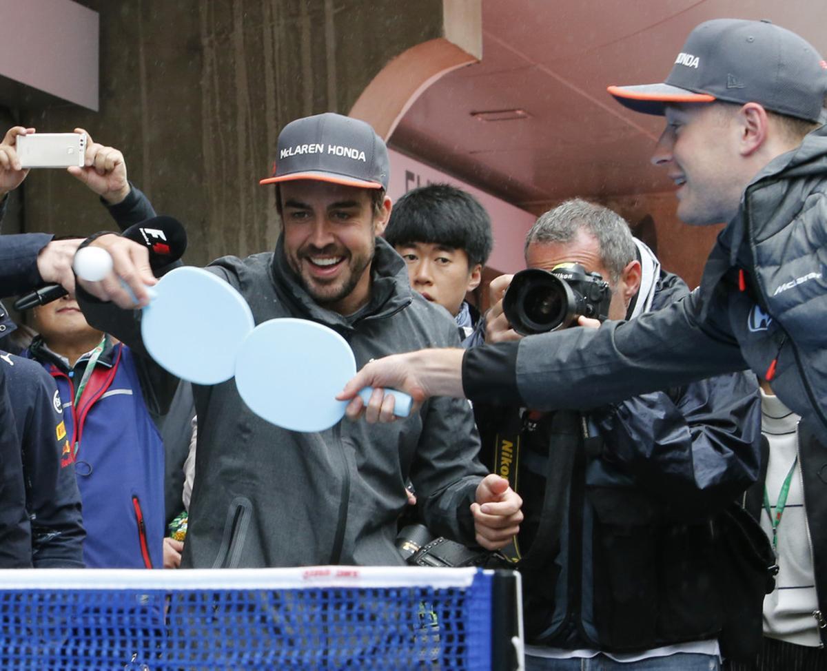 McLaren driver Fernando Alonso, left, of Spain and Renault driver Nico Hulkenberg of Germany play a table tennis ahead of the Chinese Formula One Grand Prix at the Shanghai International Circuit in Shanghai, China, Sunday, April 9, 2017. (AP Photo/Toru Takahashi)