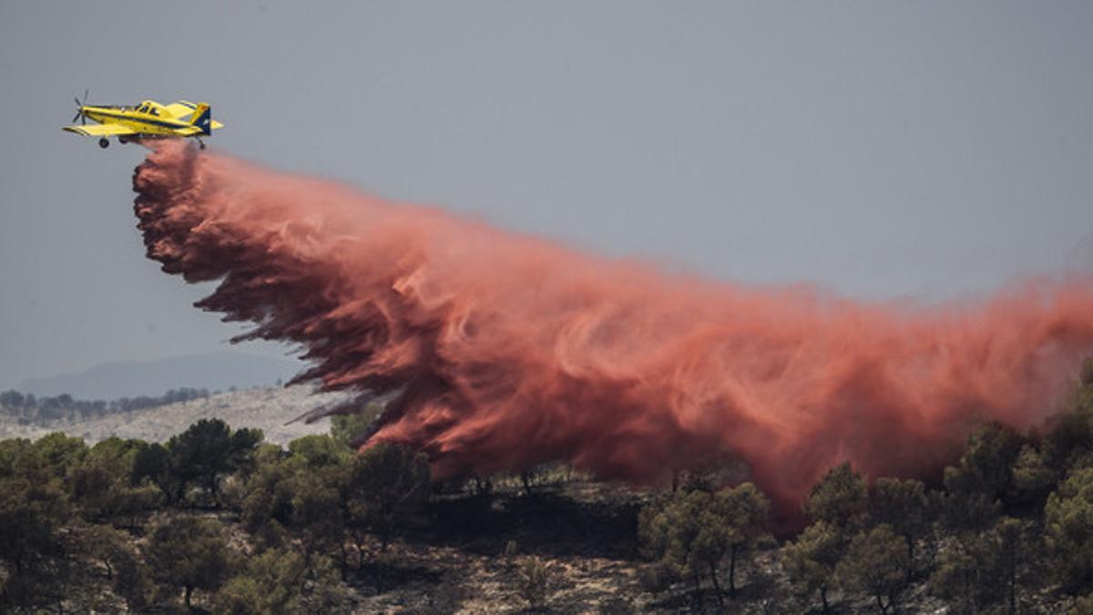 Un avión de carga similar al accidentado en Serón arroja líquido retardante sobre el parque nacional del Turia, en la localidad valenciana de Villamarxant, el pasado julio.