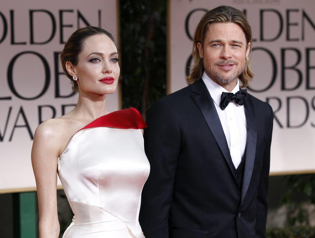 Actors Angelina Jolie and Brad Pitt pose for photographers as they arrive at the 69th annual Golden Globe Awards in Beverly Hills, California in this January 15, 2012 file photo. Oscar-winning actress Jolie said on May 14, 2013 that she had undergone a preventive double mastectomy after finding out she had a gene mutation that leads to a sharply higher risk of both breast and ovarian cancer. Jolie, writing in the New York Times, said her mother’s death from cancer at 56 and the discovery that she carried the BRCA1 gene mutation led to her decision out of fears she might not be around for her six children. REUTERS/Mario Anzuoni/Files  (UNITED STATES - Tags: ENTERTAINMENT HEALTH)