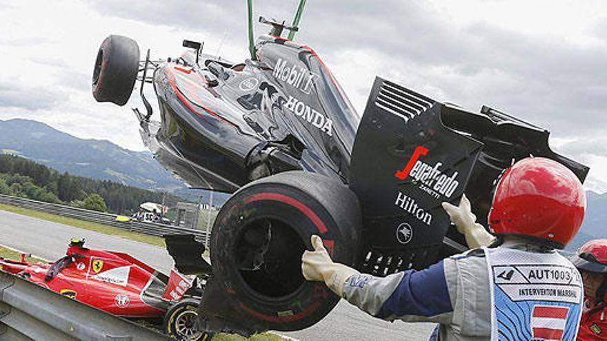 Operarios retiran el McLaren de Alonso en el GP de Austria.