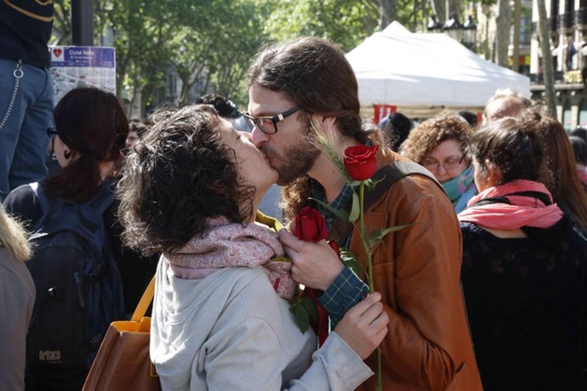 Una parella besant-se durant la diada de Sant Jordi 2014.