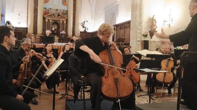 El violonchelista Willard Carter, ayer, durante su concierto con la OSPA en el monasterio de San Salvador de Celoriu, bajo la dirección de Josep Gil, a la derecha. |