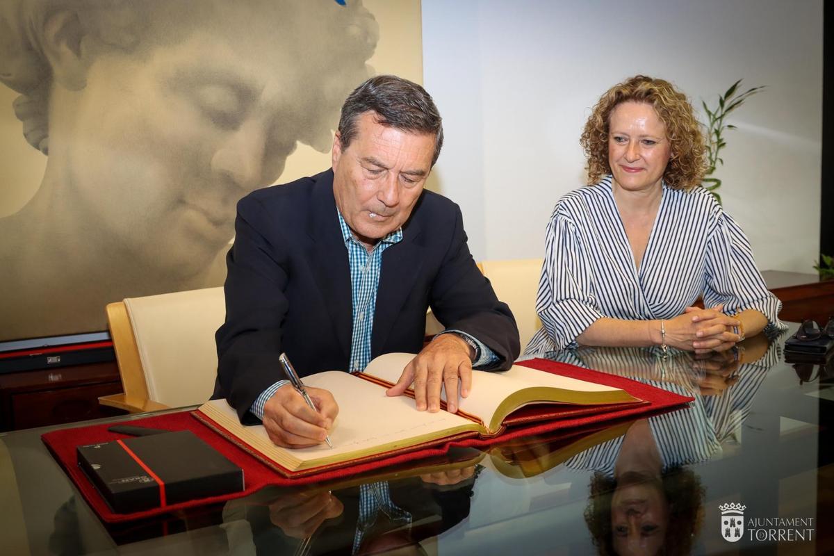 Marciano Gómez firma en el libro de honor del ayuntamiento de Torrent.