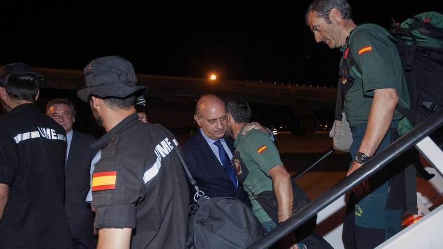 El ministro del Interior abraza a un guardia civil de montaña a su llegada a Zaragoza.