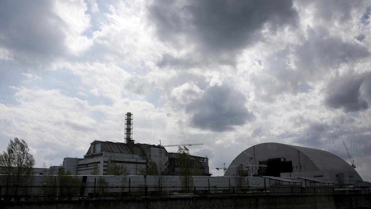 A general view shows a containment shelter for the damaged fourth reactor and the New Safe Confinement structure at the Chernobyl Nuclear Power Plant